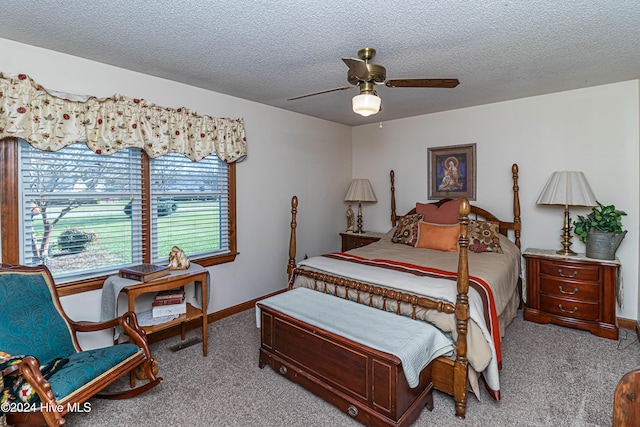 bedroom featuring a textured ceiling, light carpet, and ceiling fan