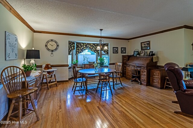 103 Shamrock Rd, Goldsboro, NC 27530 - dining room featuring crown molding, wood-type flooring, a chandelier, and a textured ceiling