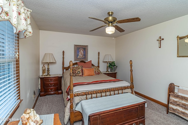 carpeted bedroom featuring a textured ceiling and ceiling fan