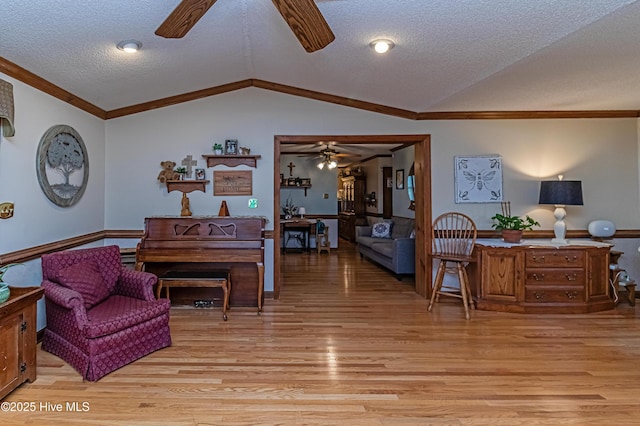 103 Shamrock Rd, Goldsboro, NC 27530 - living room featuring ceiling fan, light wood-style flooring, vaulted ceiling, a textured ceiling, and ornamental molding