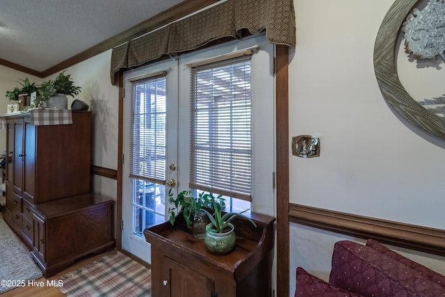 103 Shamrock Rd, Goldsboro, NC 27530 - doorway to outside with ornamental molding, a textured ceiling, and light wood-type flooring