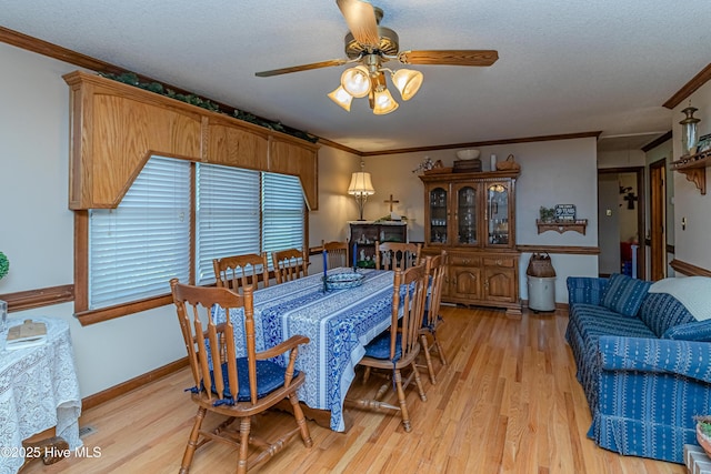 103 Shamrock Rd, Goldsboro, NC 27530 - dining room with a ceiling fan, light wood-style floors, crown molding, a textured ceiling, and baseboards