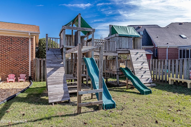 view of jungle gym featuring a lawn