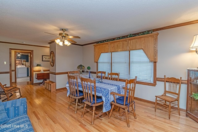 103 Shamrock Rd, Goldsboro, NC 27530 - dining room with light wood-type flooring, ornamental molding, ceiling fan, a textured ceiling, and washer / clothes dryer