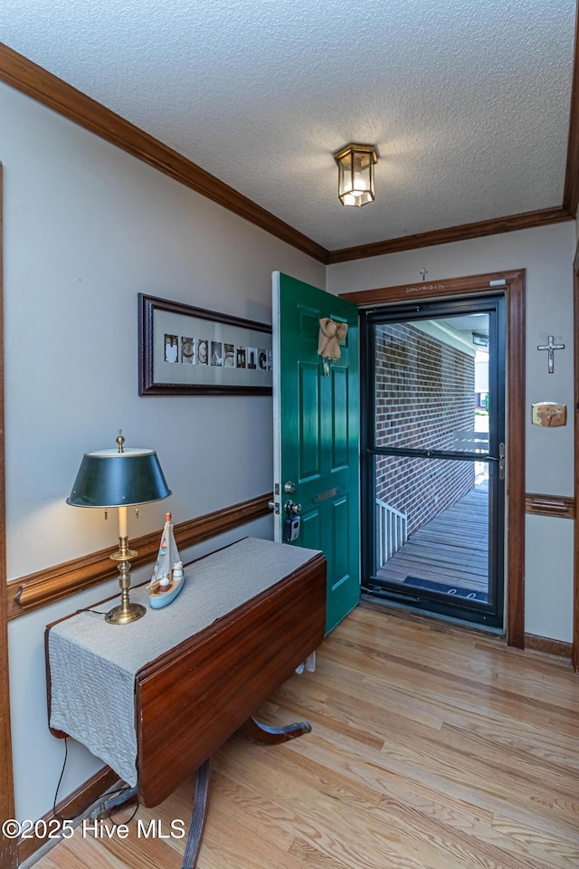 103 Shamrock Rd, Goldsboro, NC 27530 - entryway featuring crown molding, a textured ceiling, and light wood-style flooring