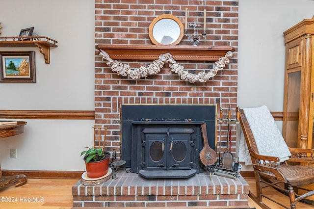 interior details with wood-type flooring and a fireplace