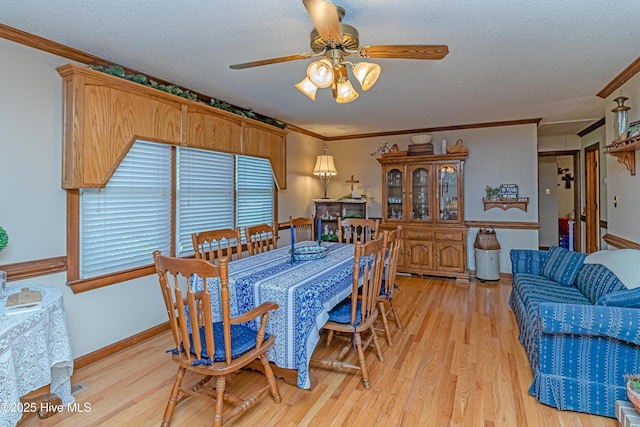 103 Shamrock Rd, Goldsboro, NC 27530 - dining space featuring a ceiling fan, light wood-style floors, crown molding, a textured ceiling, and baseboards
