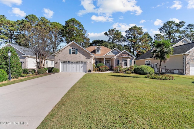 view of front of house with a front yard and a garage