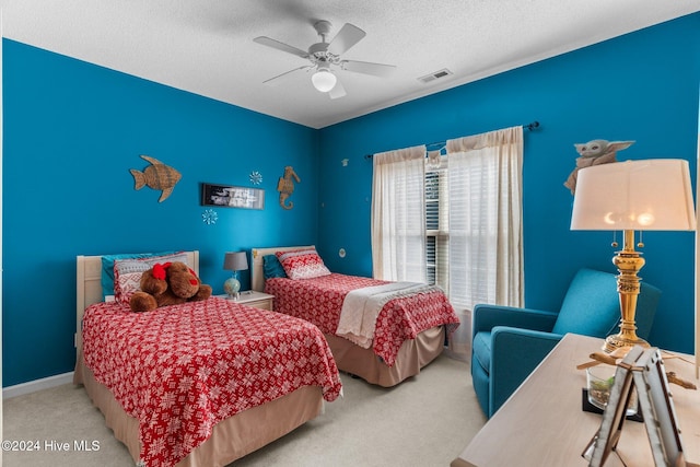 bedroom with carpet flooring, ceiling fan, and a textured ceiling