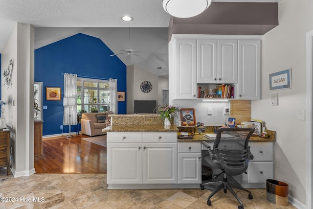 office with light wood-type flooring, vaulted ceiling, ceiling fan, and built in desk