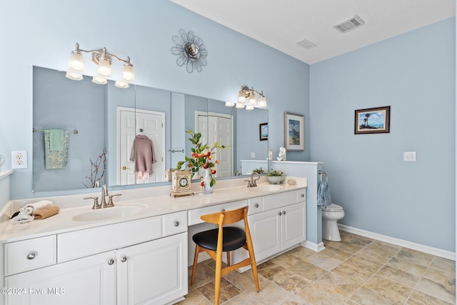 bathroom featuring vanity and toilet