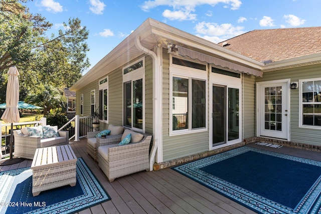 wooden deck with an outdoor living space