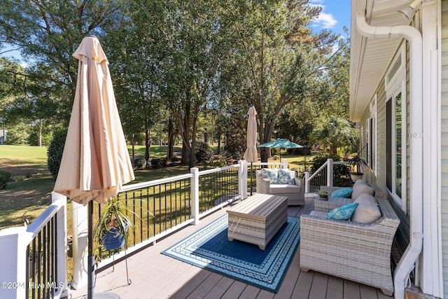 wooden terrace featuring an outdoor living space and a yard