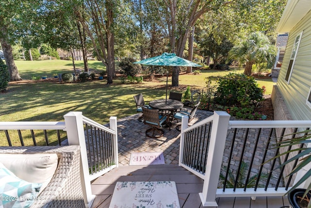 wooden terrace with a yard and a patio area