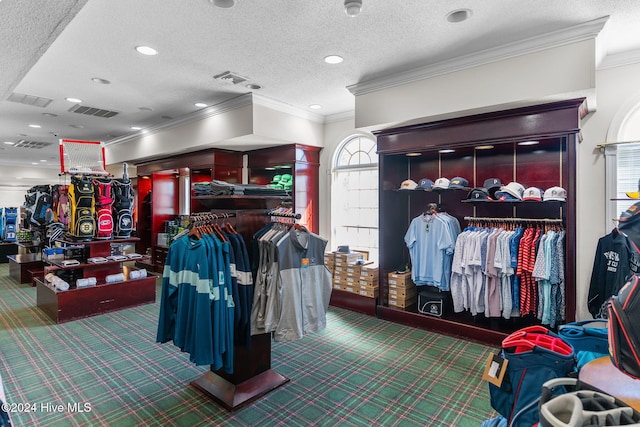 interior space with carpet, ornamental molding, and a textured ceiling