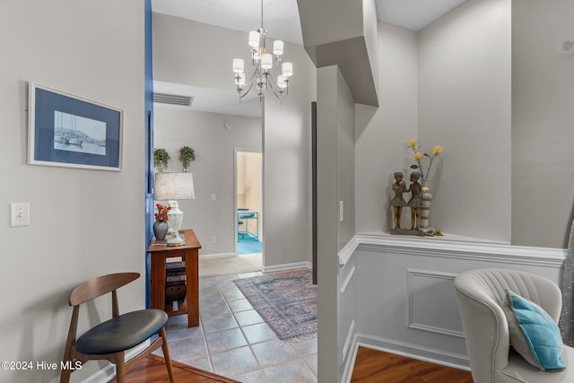 foyer featuring a chandelier and wood-type flooring