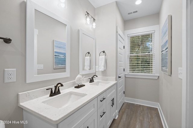 bathroom with hardwood / wood-style floors and vanity