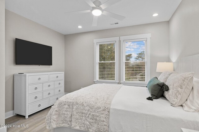 bedroom with ceiling fan and light wood-type flooring