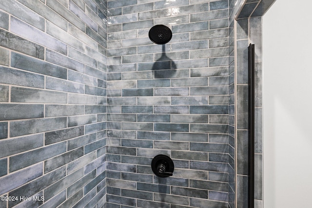 bathroom with a tile shower