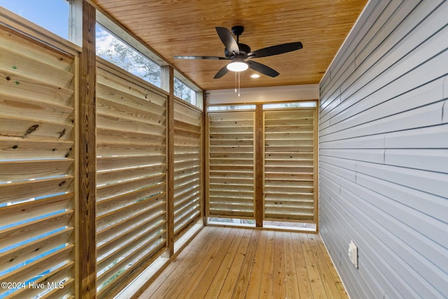 unfurnished sunroom with ceiling fan and wood ceiling