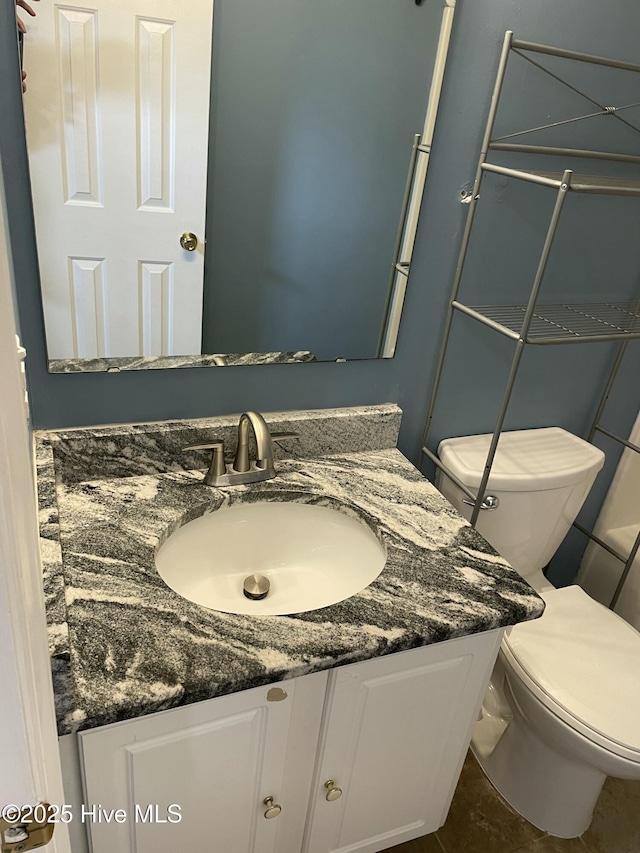 bathroom featuring vanity and toilet