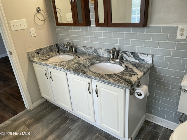 bathroom with decorative backsplash and vanity