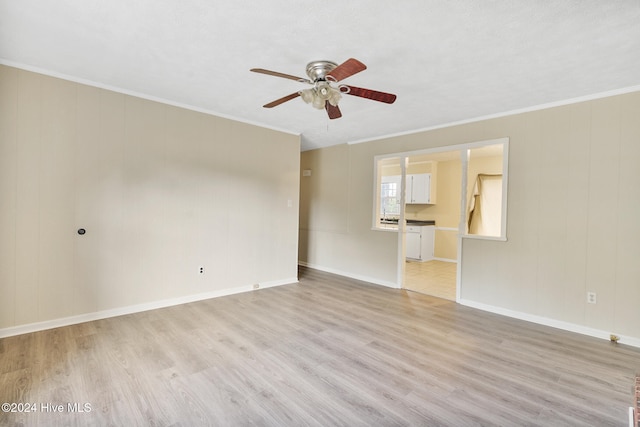 unfurnished room with light hardwood / wood-style floors, ceiling fan, and crown molding