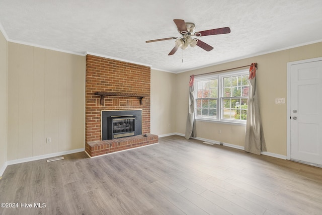 unfurnished living room with a fireplace, light wood-type flooring, and crown molding