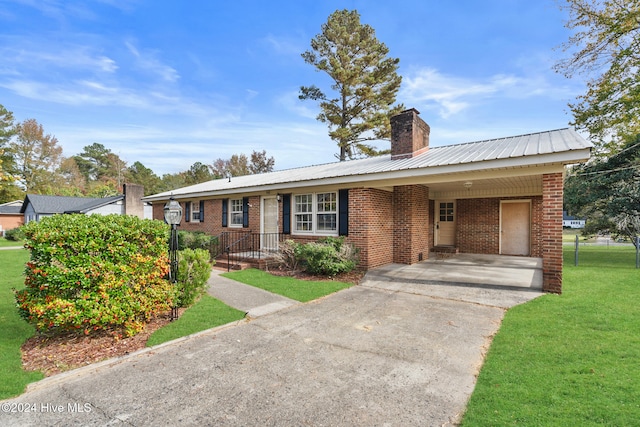 single story home with a front lawn and a carport