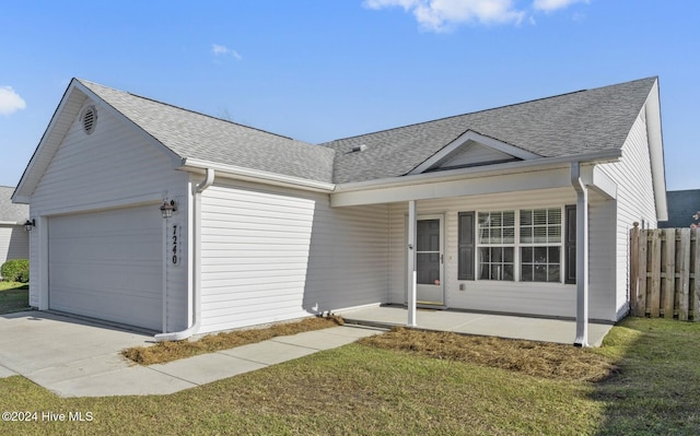 ranch-style house featuring a garage, a porch, and a front yard