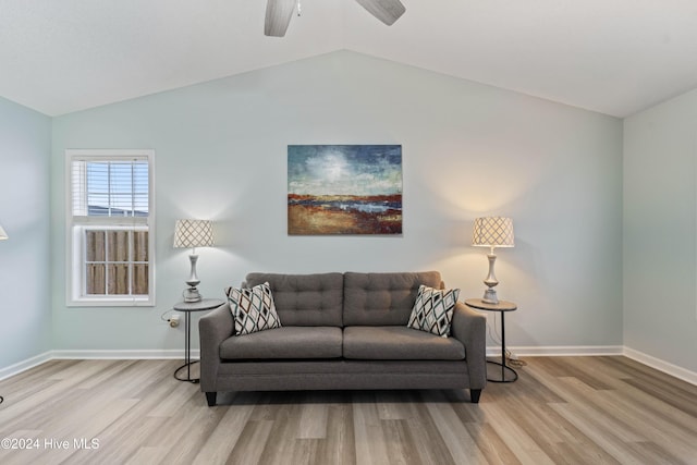 living room featuring lofted ceiling, ceiling fan, and light wood-type flooring