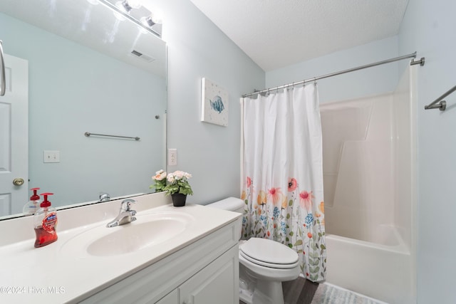 full bathroom with vanity, a textured ceiling, shower / tub combo with curtain, hardwood / wood-style floors, and toilet