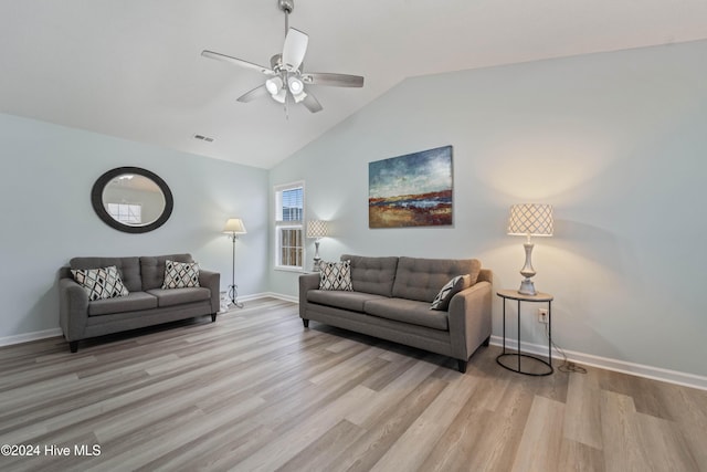 living room featuring ceiling fan, light hardwood / wood-style floors, and lofted ceiling