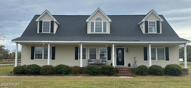 view of front of house featuring covered porch and a front lawn