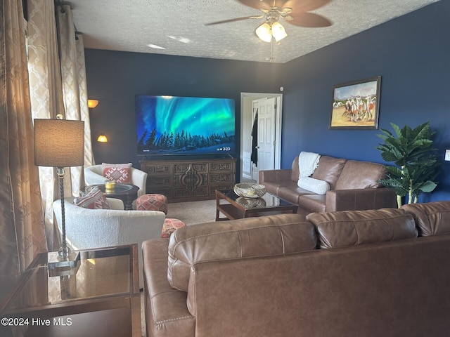 living room with a textured ceiling and ceiling fan