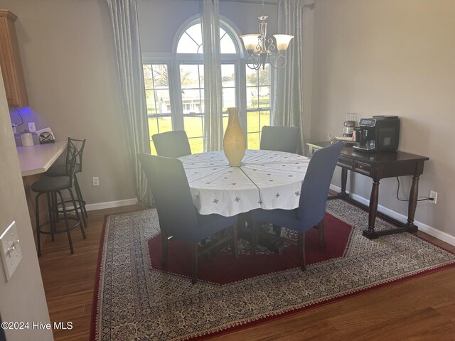 dining room featuring hardwood / wood-style flooring and a notable chandelier