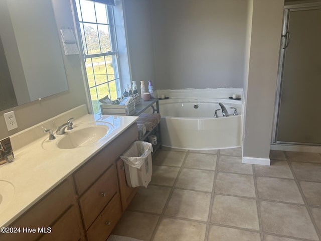 bathroom featuring independent shower and bath, vanity, and tile patterned floors