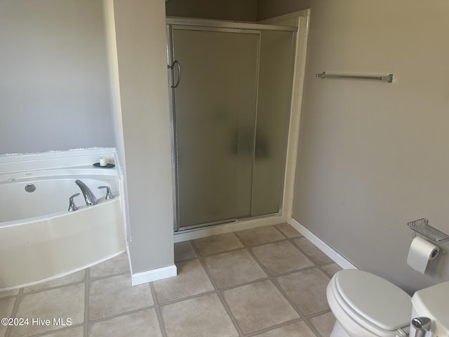 bathroom featuring tile patterned flooring, toilet, and plus walk in shower