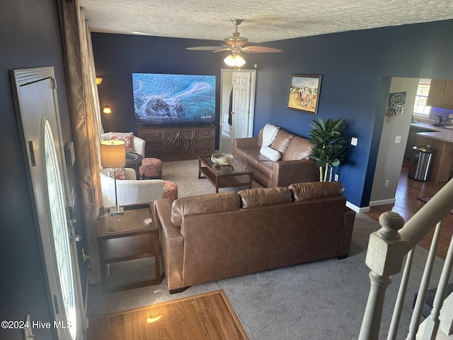 living room featuring a textured ceiling and ceiling fan