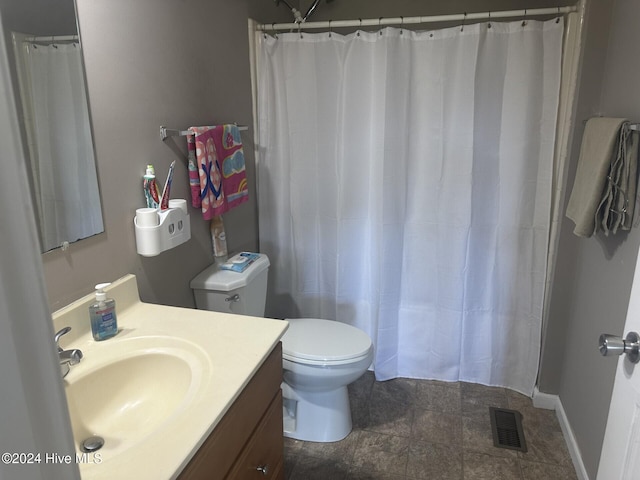 bathroom with walk in shower, vanity, and toilet