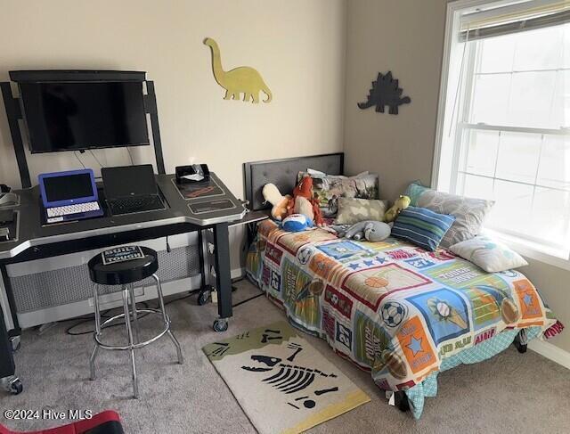 bedroom featuring light colored carpet