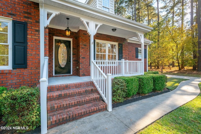 view of exterior entry with a porch