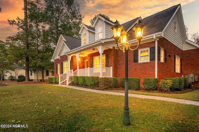 view of front of house with a lawn and covered porch