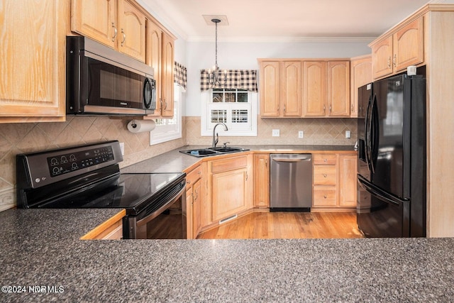 kitchen with black appliances, light brown cabinetry, light hardwood / wood-style floors, and crown molding