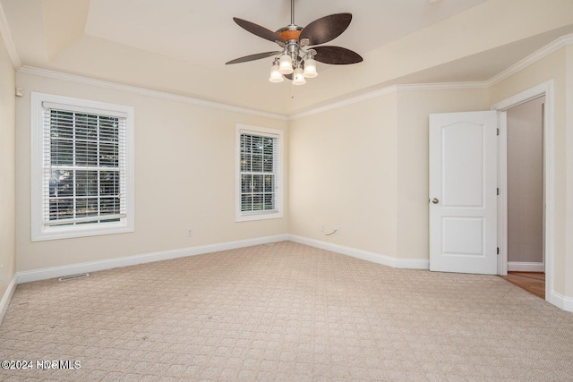 carpeted empty room featuring ceiling fan and crown molding