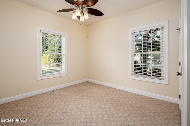 carpeted empty room featuring ceiling fan