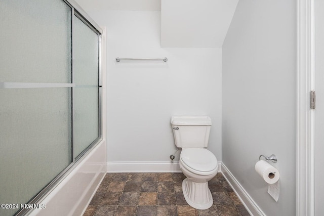 bathroom with enclosed tub / shower combo and toilet