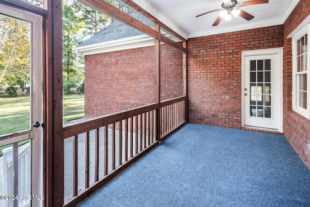 unfurnished sunroom with ceiling fan