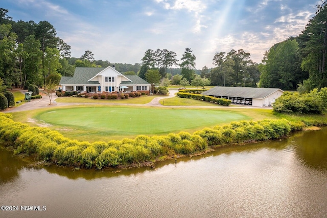 view of home's community with a yard and a water view