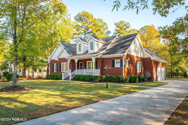 cape cod house with a garage, covered porch, and a front yard